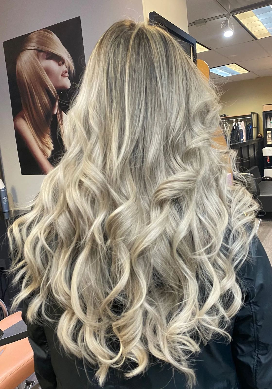 Bright blonde balayage curls finished look